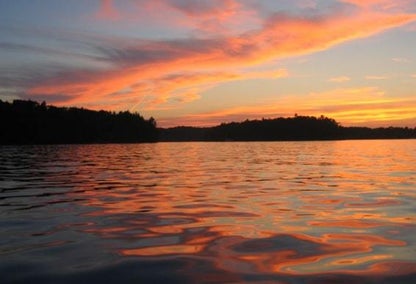 Sun setting and reflecting off of the water of a lake