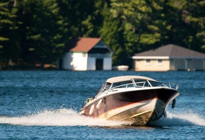 A boat speeding fast on the waters of Dickie Lake, ON
