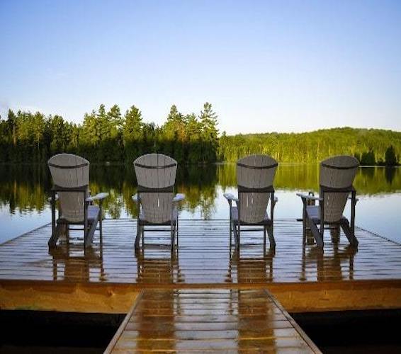Muskoka deck chairs in front of a lake