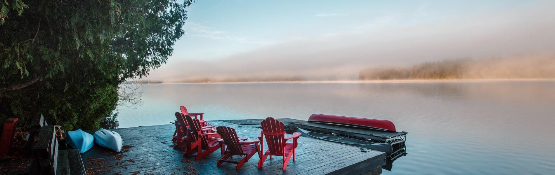 View of dock on Ontario waterfront property overlooking the sunset