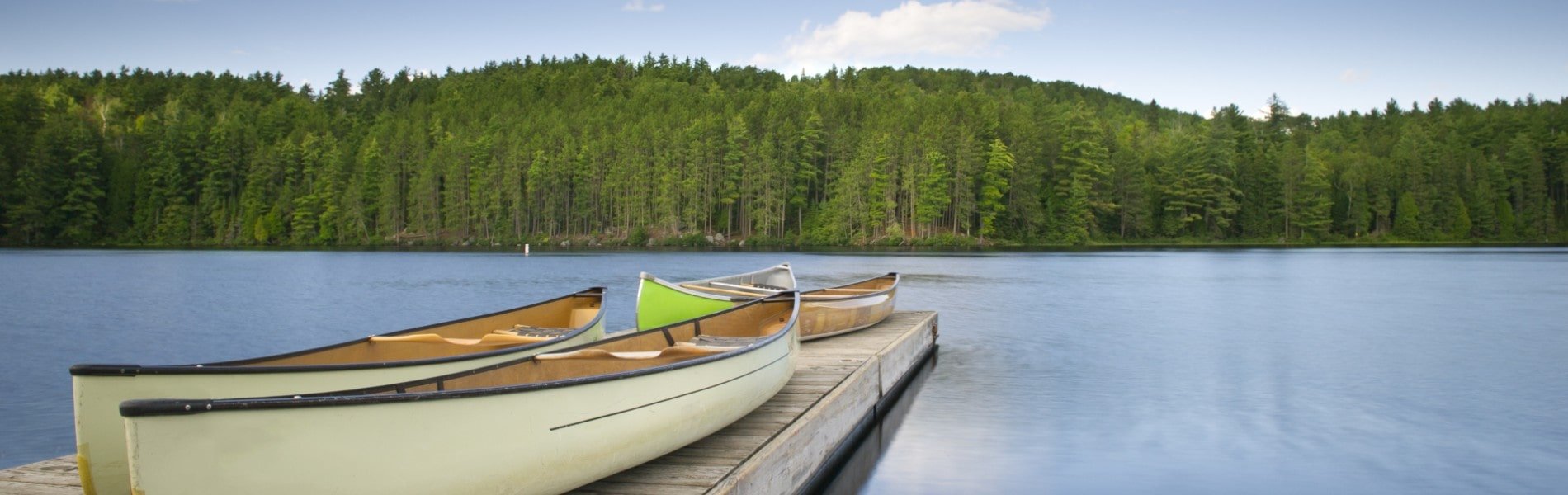 canoes on a dock overlooking a muskoka lake