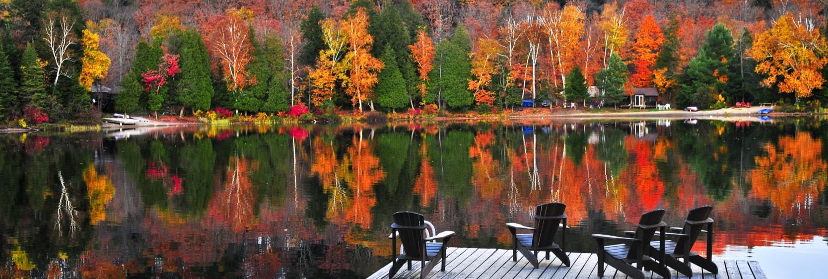 Chairs on a dock overlooking stunning Muskoka Lakes and vibrant forestry near Bala