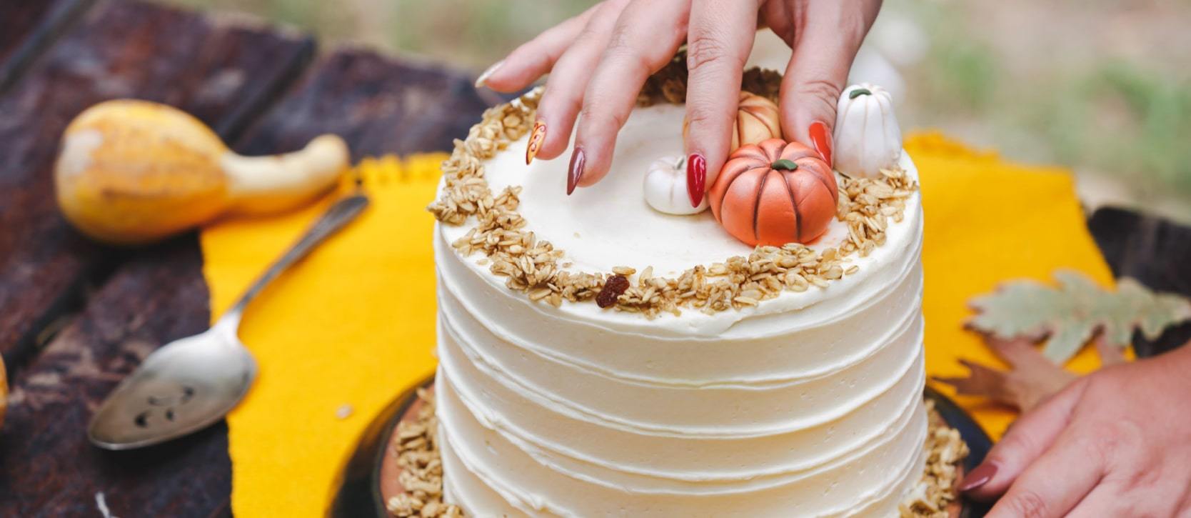 Cake being decorated with fall decorations