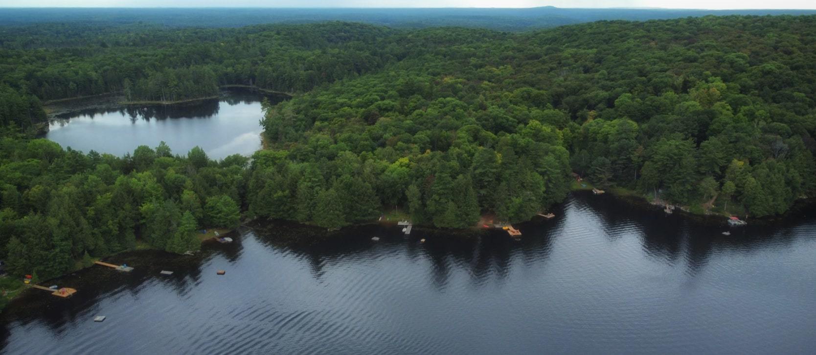 Overhead shot of beautiful blue lake and forestry in Highlands East, Haliburton