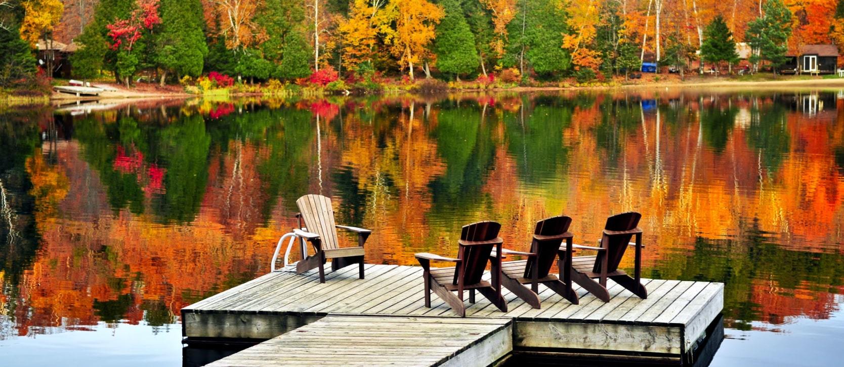 Lounge chairs on a dock in the fall in Muskoka
