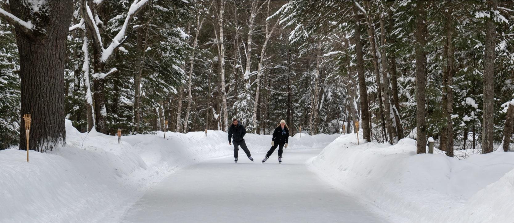 Two people ice skating in beautiful Arrowhead Park in Muskoka in the winter