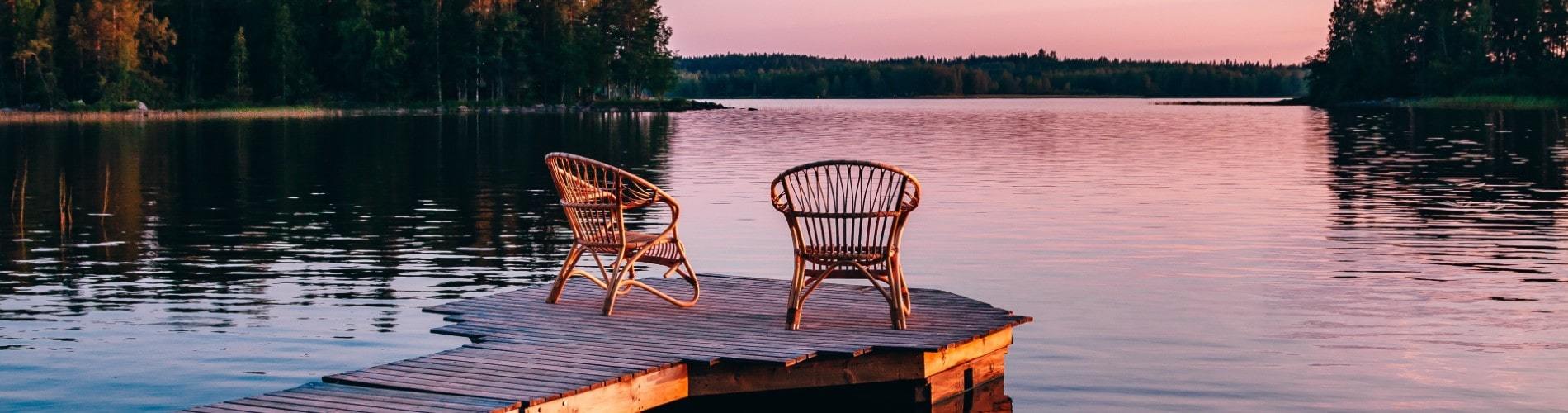 Beautiful view of two chairs on a dock overlooking scenic Lake Muskoka 