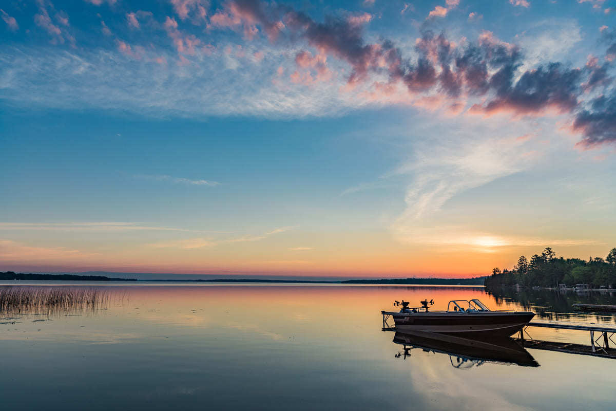 A boat sitting on a dock at dusk in Ontario.